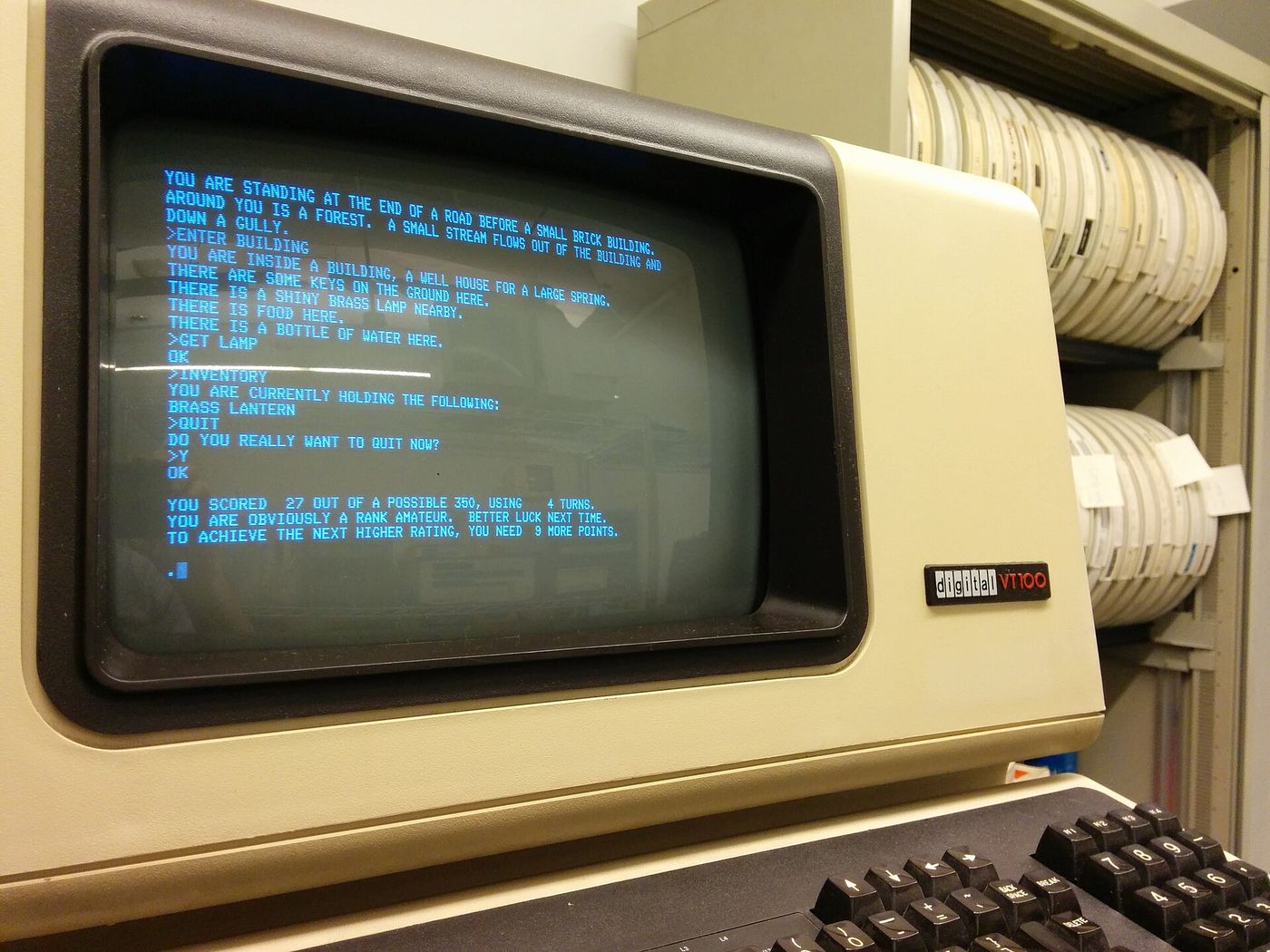 Colossal Cave Adventure running on a VT100 terminal, green-blue text on a dark screen
